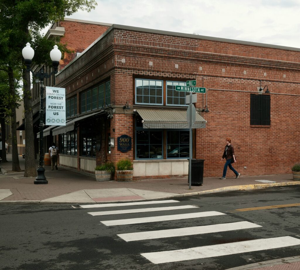 Downtown Bend, Oregon street scene with historic brick buildings and shops near Wall Street and Minnesota Avenue.